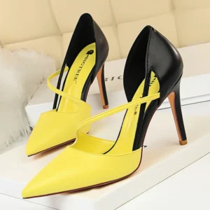 black and yellow heels standing on a white carpet