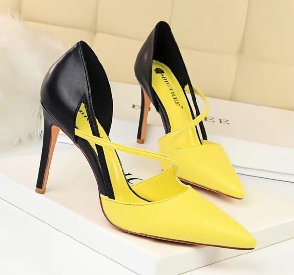 black and yellow heels standing in the bright room