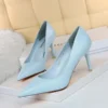 bright blue heels side and front view standing on a white carpet