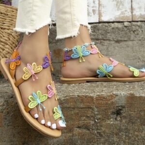 woman walking in butterfly sandals on the stairs