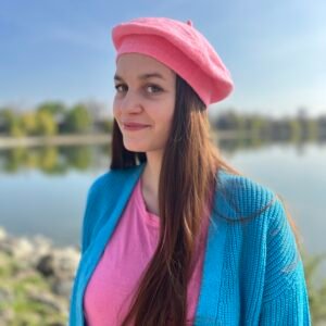 candy pink beret, front view, on a model ,a lake in the background