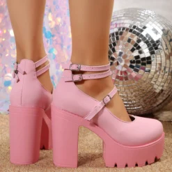 chunky pink heels on feet, their backside is shown, disco light lays behind them