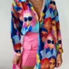 woman wearing colorful blouse and pink shorts