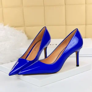 dark blue heels standing on a white carpet