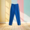 dark blue pants hanging in the air, pastel colored walls in the background