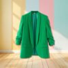 green blazer hanging in the air, pastel colored walls in the background