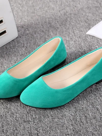 green flats front view on a grey carpet