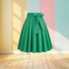 green skirt front view, pastel colored wall in the background