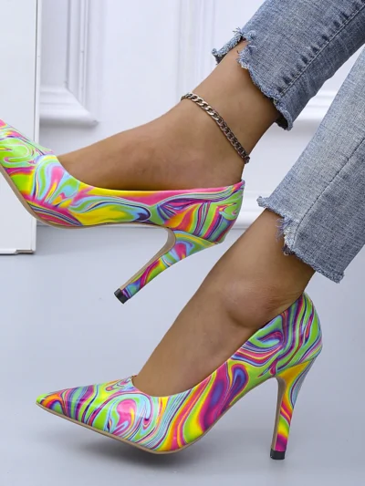 woman wearing multicolor heels and jeans, white room in the backgorund