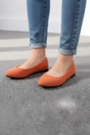 woman wearing orange flats