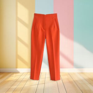 orange pants front view, pastel colored wall in the background