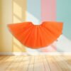 orange tulle skirt front view, pastel colored walls in the background