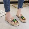 pineapple flats on the feet, front view, wooden floor under them