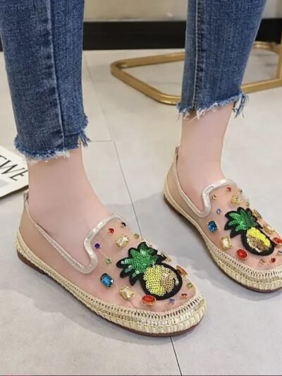 woman wearing pineapple flats and jeans