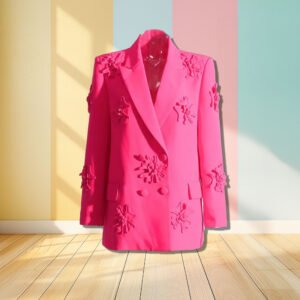 pink blazer with appliques front view, pastel colored wall in the background