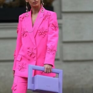 woman wearing pink blazer with appliques and a lilac bag