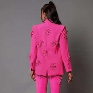 woman turned to her back wearing pink blazer with appliques