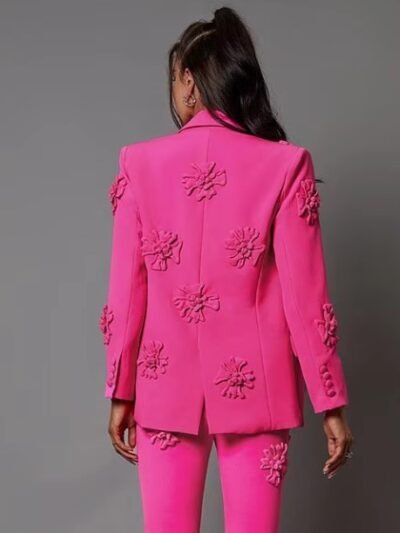 woman turned to her back wearing pink blazer with appliques