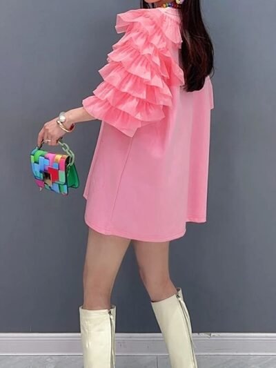 woman wearing pink dress with hearts, turned to the back