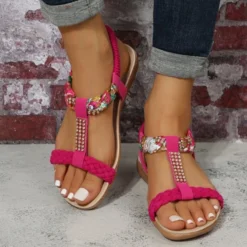 woman wearing pink flat sandals