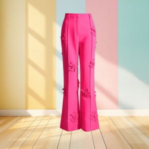 pink wide leg pants front view, pastel colored wall in the background