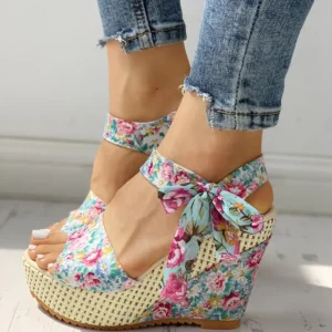 platform floral sandals front view, white floor under them