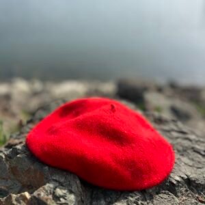 red beret laying on the grey stones