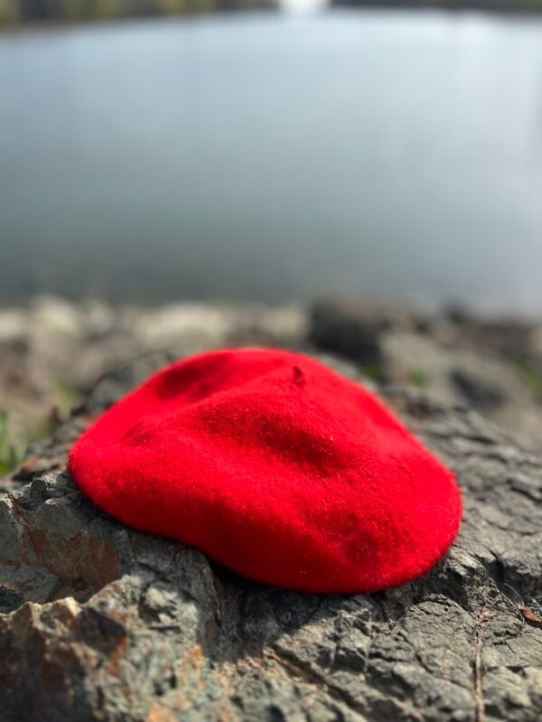 red beret laying on the grey stones