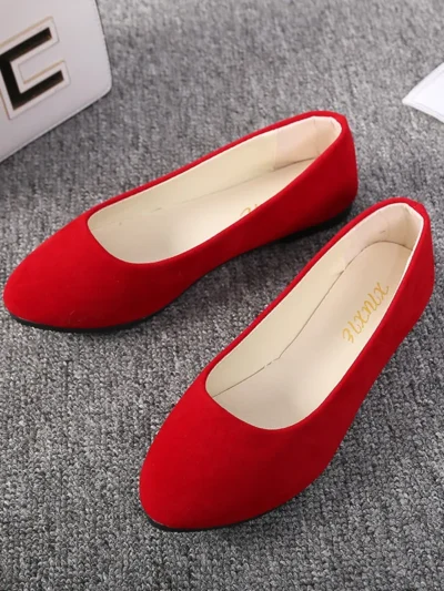 red flats front view, standing on a grey carpet