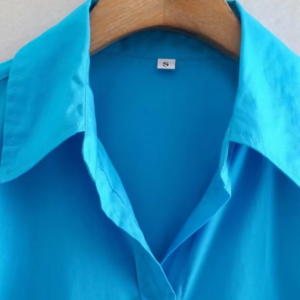 turquoise blouse front view on a hanger, the collar is shown