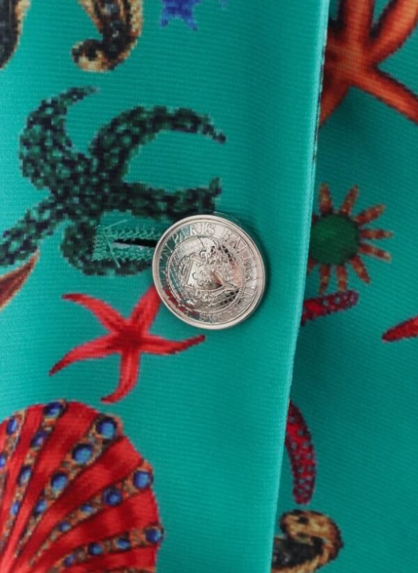 the button of the turquoise blazer