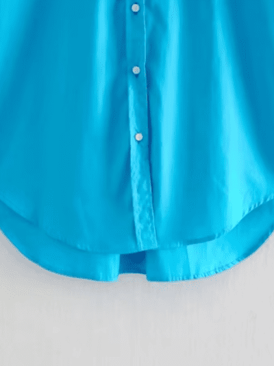 turquoise blouse front view on a hanger, bottom part visible