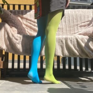 woman turned to her back wearing two color colorful tights, green and blue variation