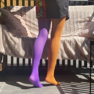 woman walking in two colors colorful tights, purple and orange variation