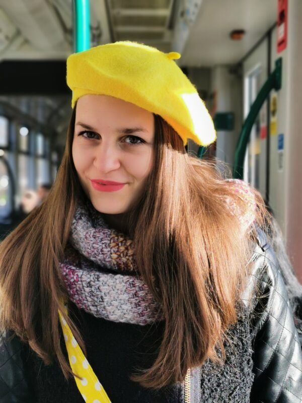 woman wearing a yellow beret and a colorful scarf