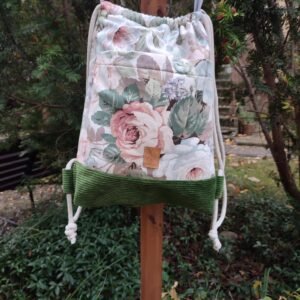 handmade floral bag front view, hanging on a fence