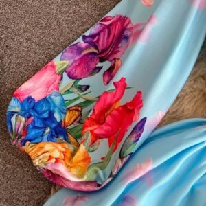 the sleeve of the blue floral dress