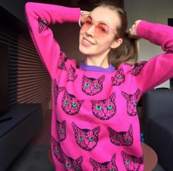 girl wearing cat sweater and glasses