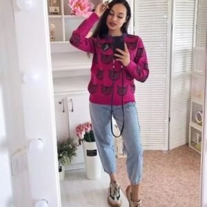 woman wearing cat sweater and jeans