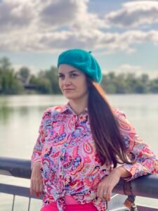 colorful clothes collection front view featuring a girl wearing turquoise beret and multicolor blouse