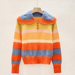 cute orange sweater on a hanger on the beige background