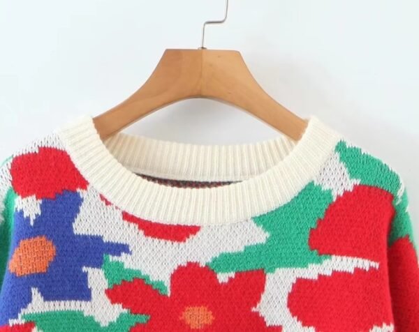 the collar of the floral sweater hanging on a hanger