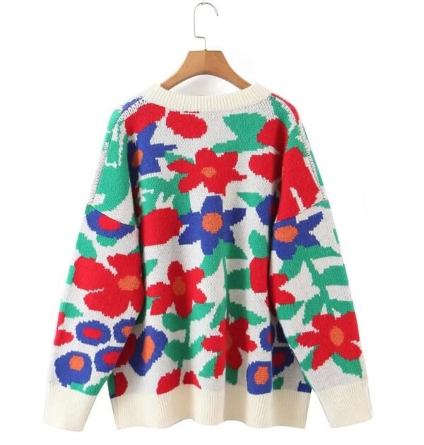 the back side of the floral sweater hanging on a hanger on the white background