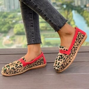 woman walking in leopard print loafers