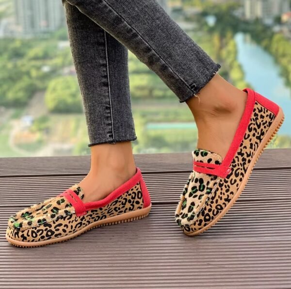 woman walking in leopard print loafers