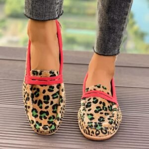 woman wearing leopard print loafers on the brown floor