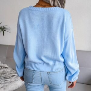 woman turned to her back wearing light blue cardigan