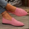 woman wearing light pink loafers