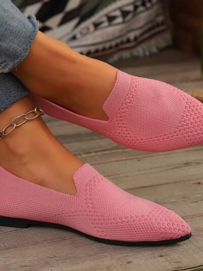 woman wearing light pink loafers