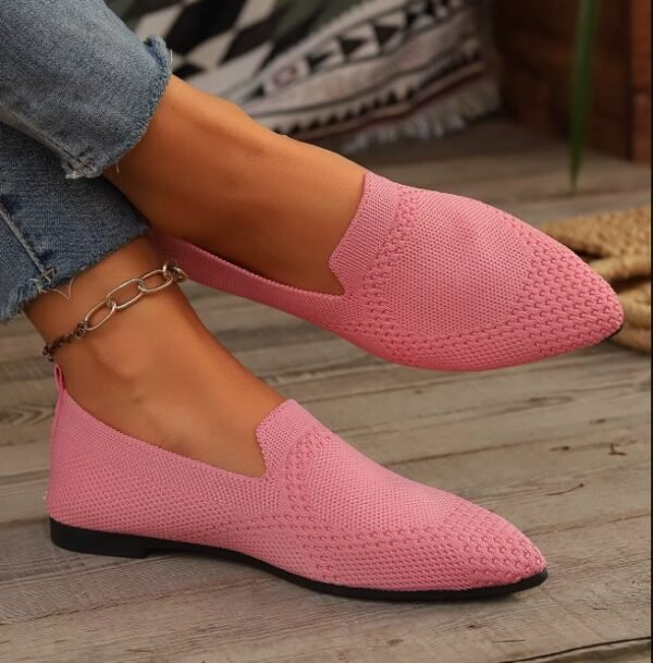 woman wearing light pink loafers